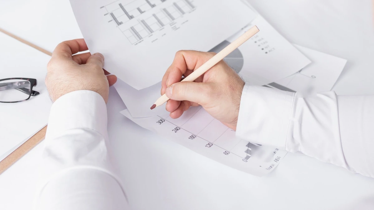 Reviewing printed clinical data charts, illustrating the Mounjaro weight loss by week timeline